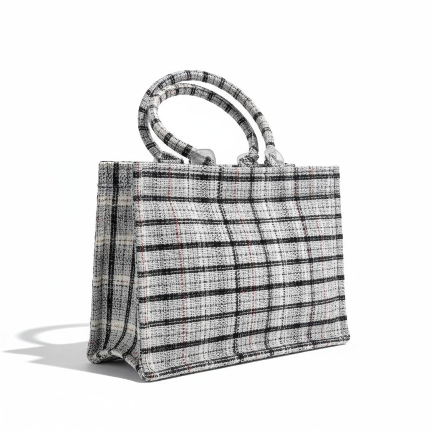 Angle view of a classic black and white tweed book tote bag.