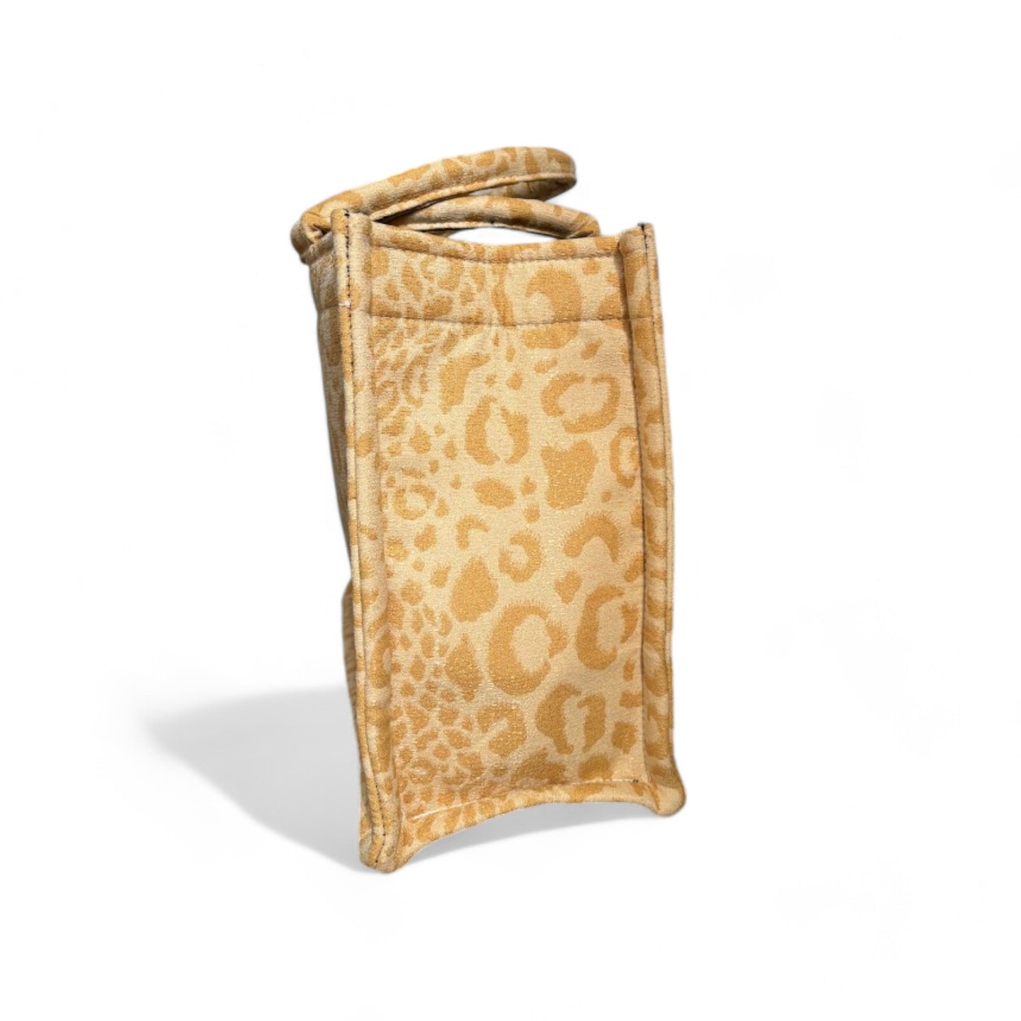 A yellow leopard print tote bag showcasing its side structured shape and reinforced seams.