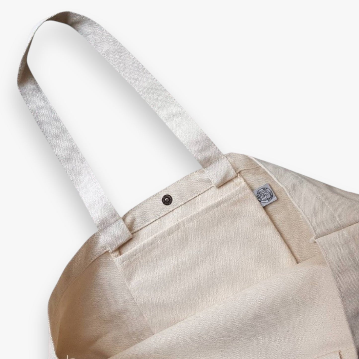 Café Hopper tote bag interior pocket and secure snap closure for practical daily use.