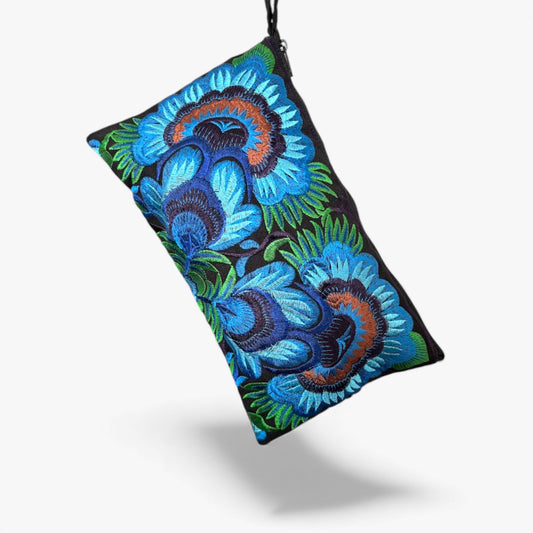 Artisan handmade clutch bag with bold embroidered blue and green floral design.