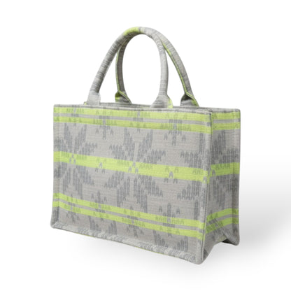 A sturdy light grey tote bag with neon green stripes with two top handles.