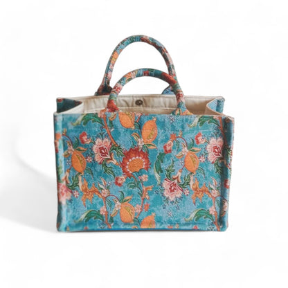 The blue vintage floral tote with double handles and sturdy structure, viewed from a high angle.