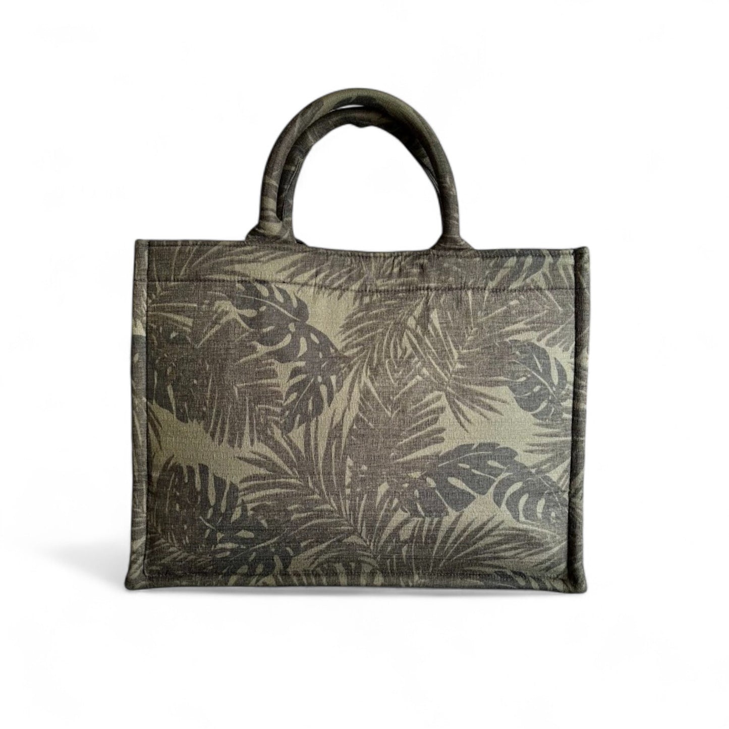 A book tote featuring black and green monstera and palm leaf patterns in the front view.