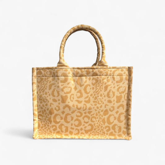 Front view of a yellow leopard handmade tote with soft double handles and a structured design.