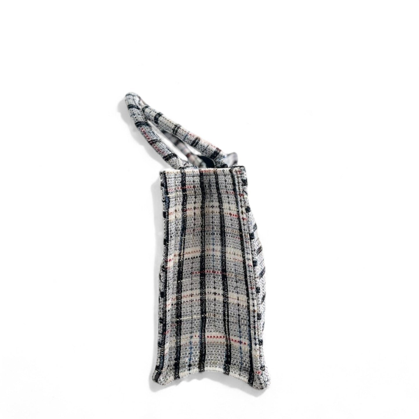 Side view of a classic plaid-patterned white tweed book tote bag.
