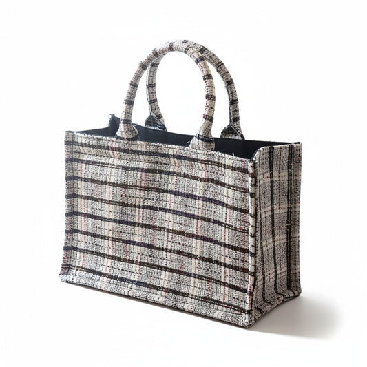 A luxury white tweed book tote with top handles in a front angled view.
