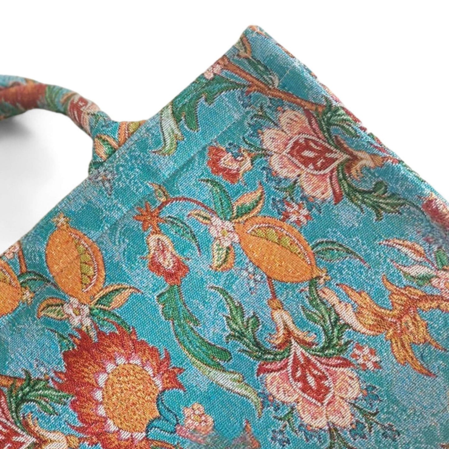 A close-up of the vintage blue floral tote bag, highlighting the intricate jacquard fabric and pattern.