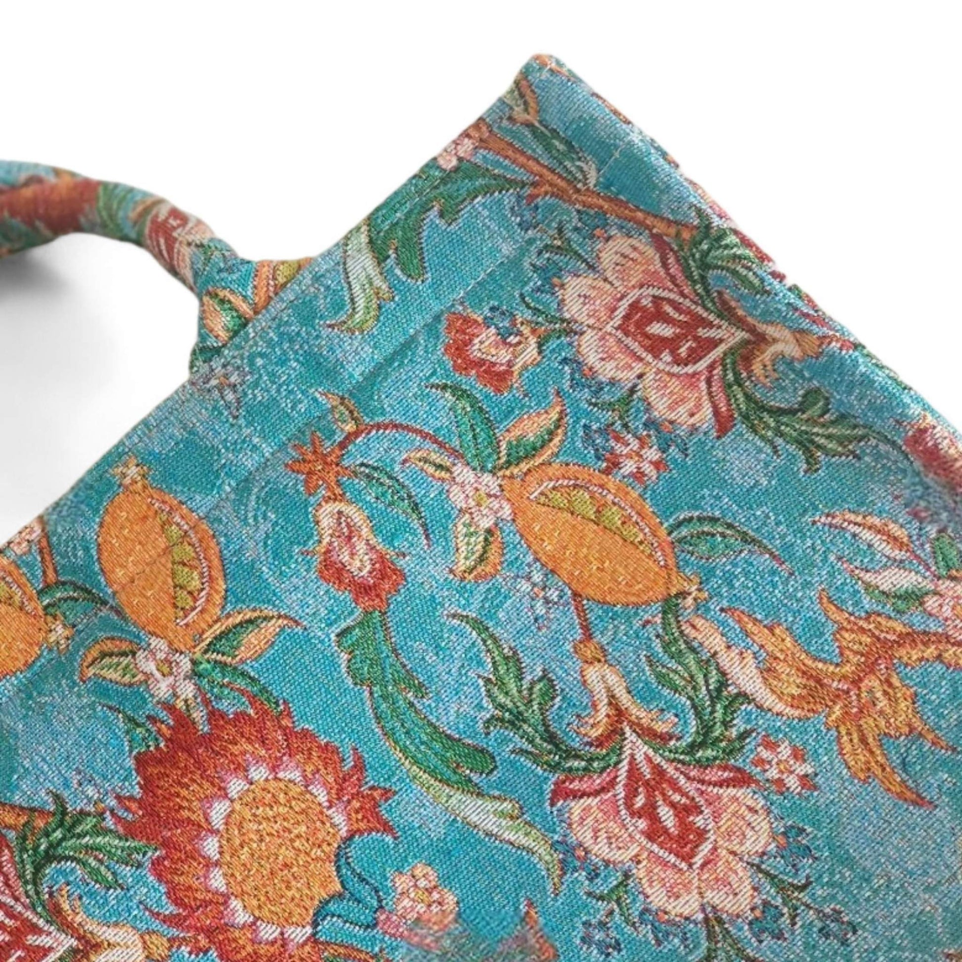 A close-up of the vintage blue floral tote bag, highlighting the intricate jacquard fabric and pattern.