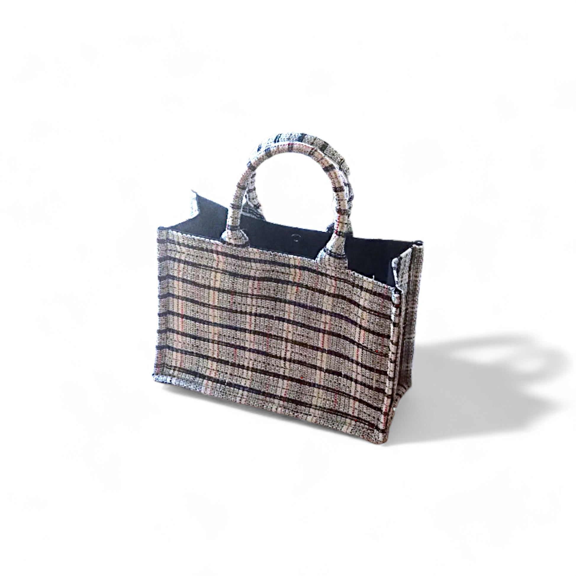 Top view of a white tweed book tote with top handles and black lining.