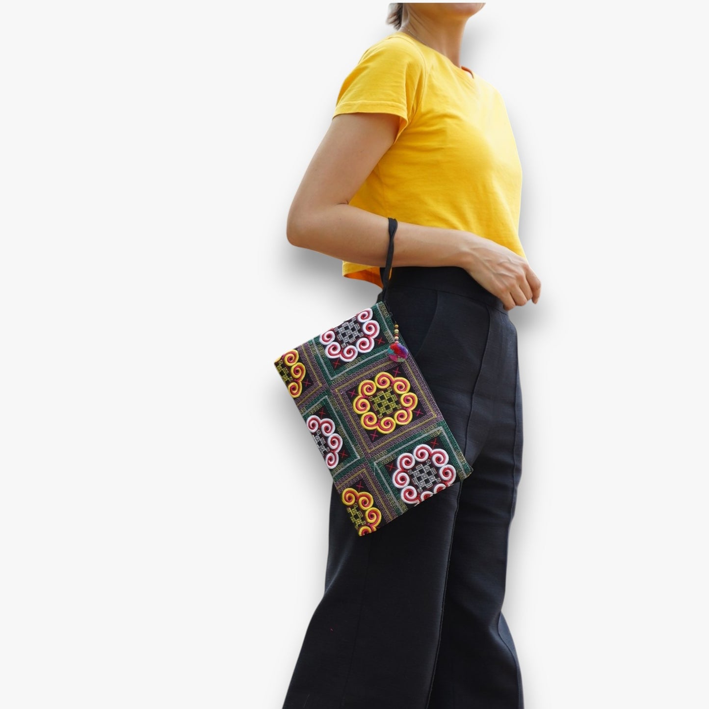 Handmade ethnic clutch wristlet with colourful embroidery styled as a fashion accessory.