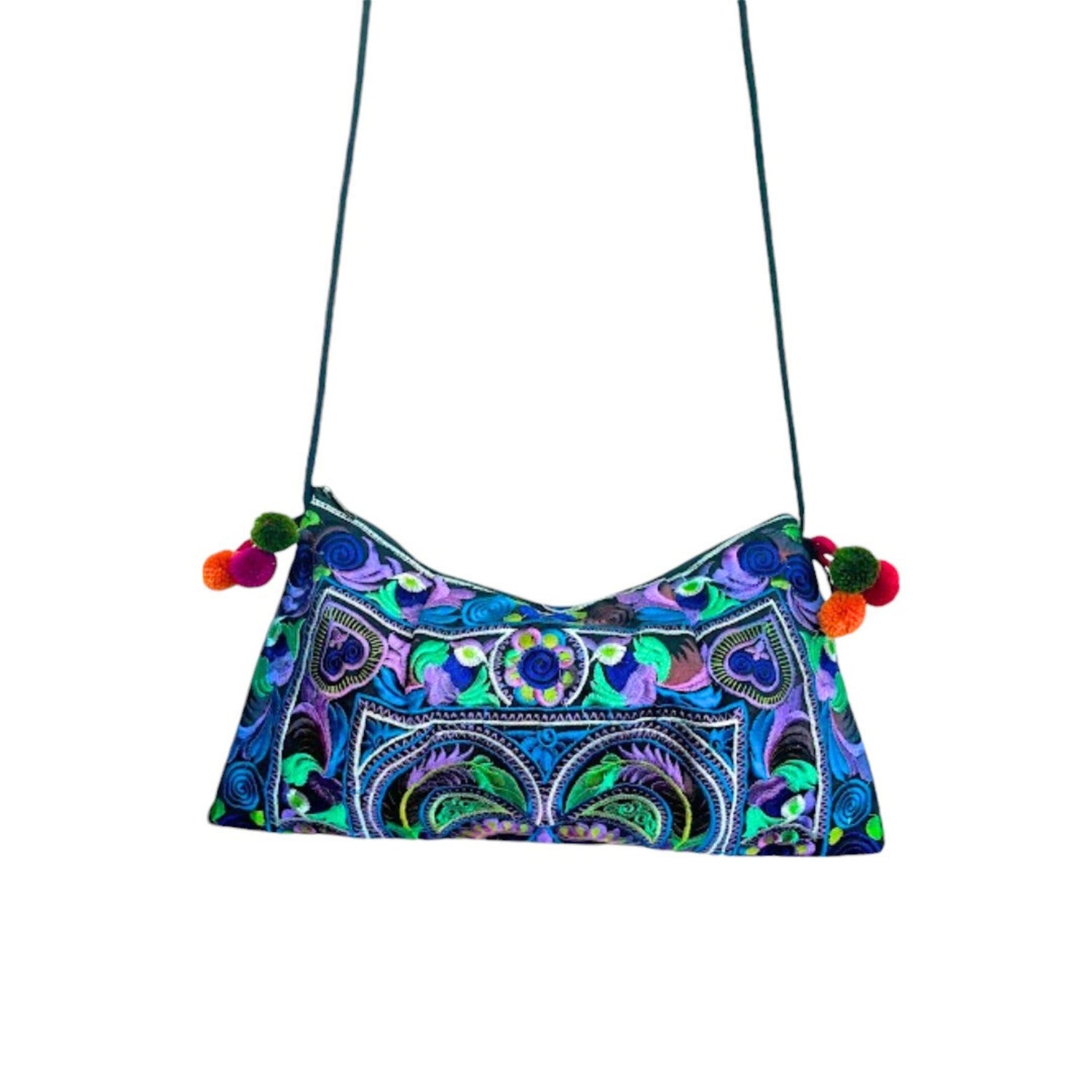 A blue multicoloured embroidered crossbody bag with colourful decorative pom poms.