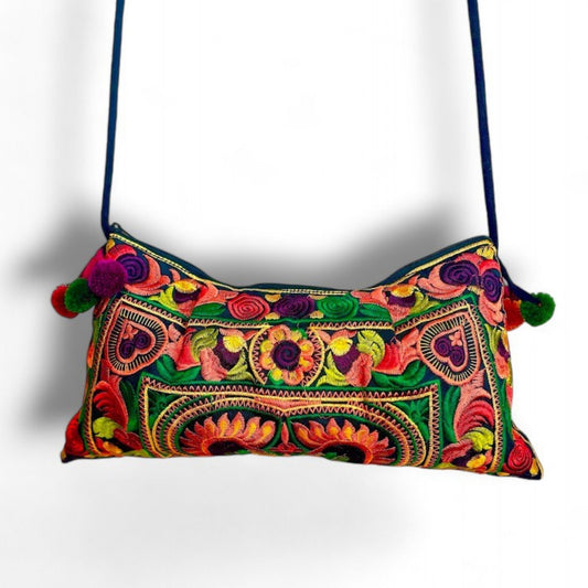 An orange multi-colour embroidered bag with colourful mini pompom charms.