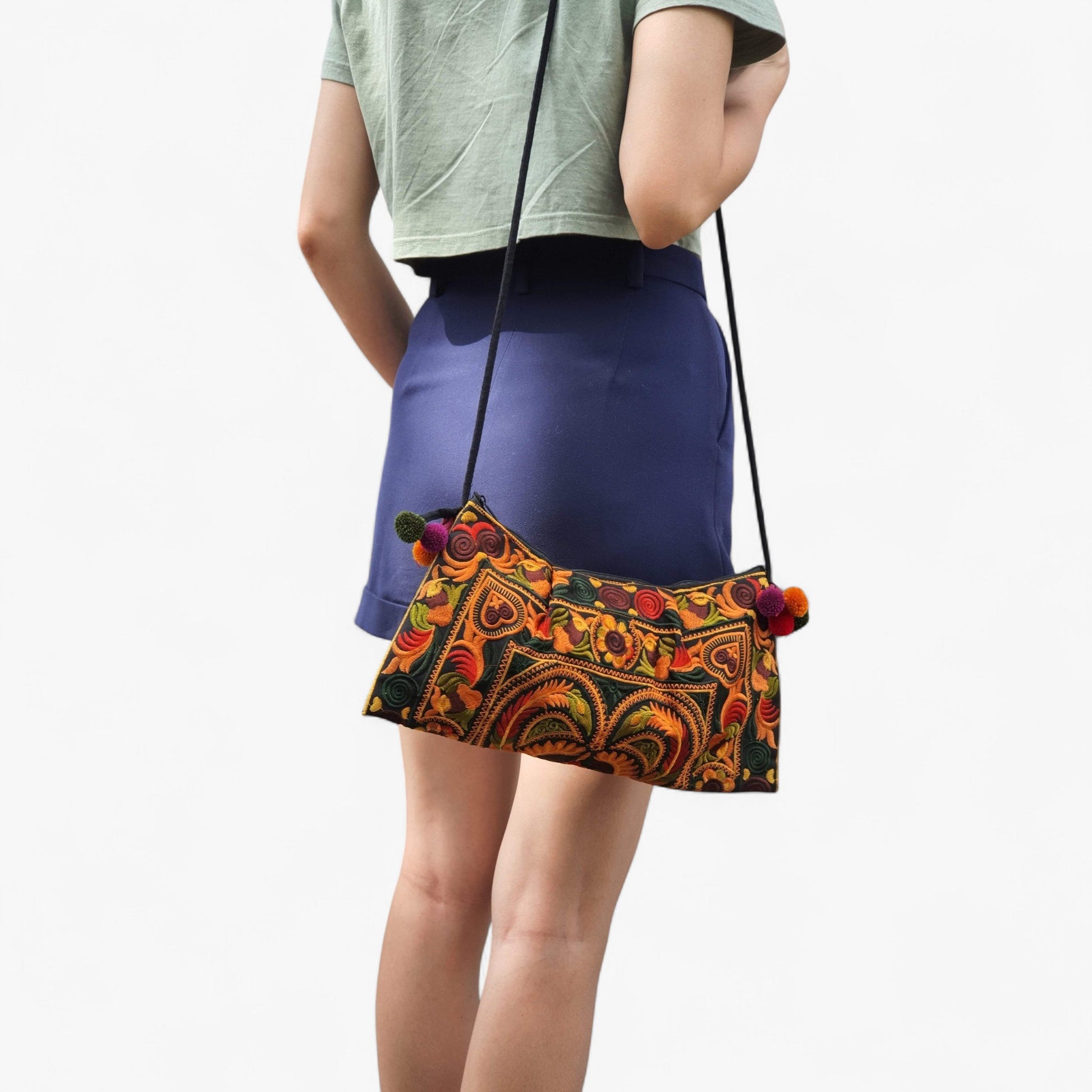 A model carrying a Mandarin multi-coloured embroidered ag on her shoulder.