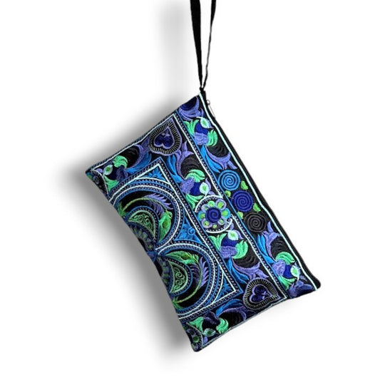 A lightweight rectangular embroidered blue wristlet bag with a floral and bird pattern.