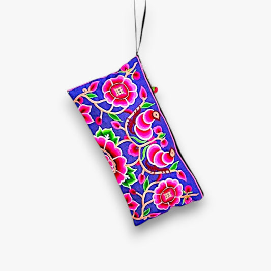 A vibrant pink clutch with Hmong peony embroidery and wrist strap - front.