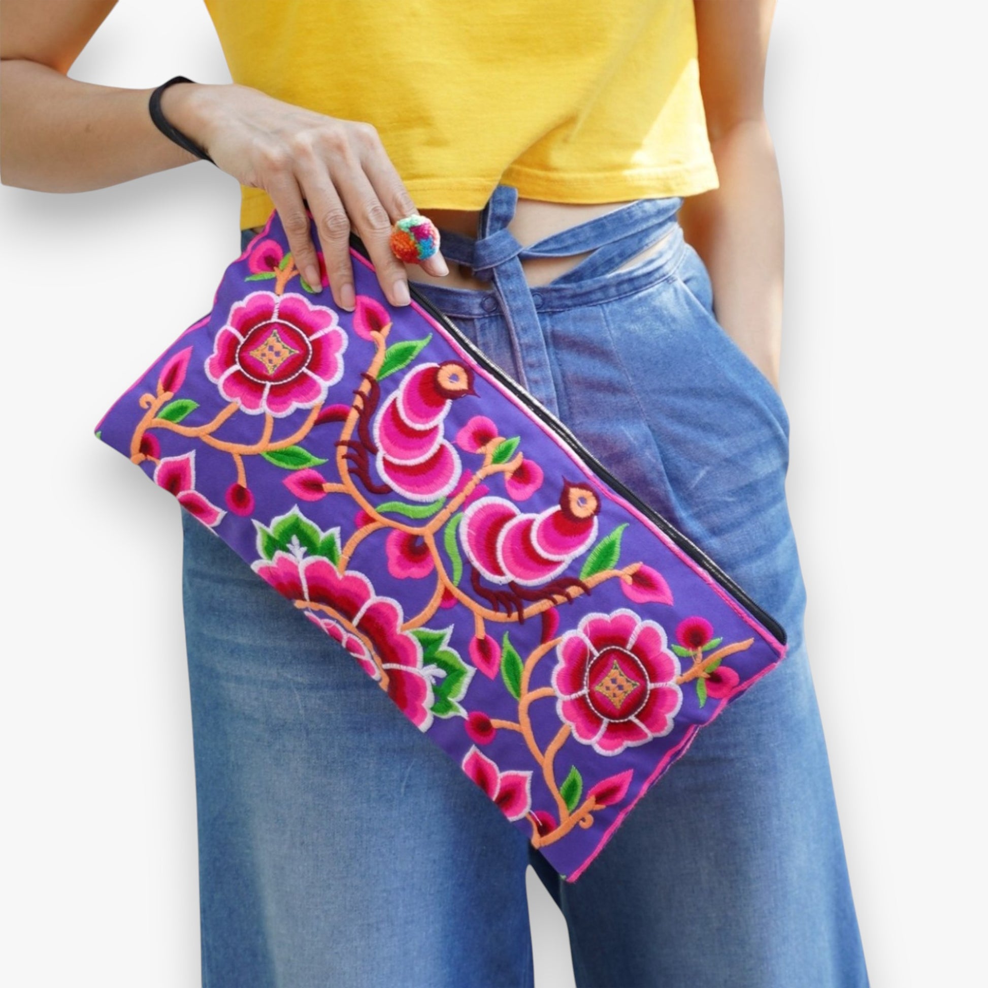 Model carrying a handmade Hmong clutch with peony embroidery on her wrist and styled with casual outfit.