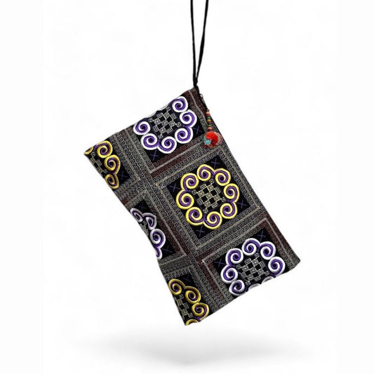 A handmade traditional Hmong embroidery bag with a wrist strap and mini pom-pom.