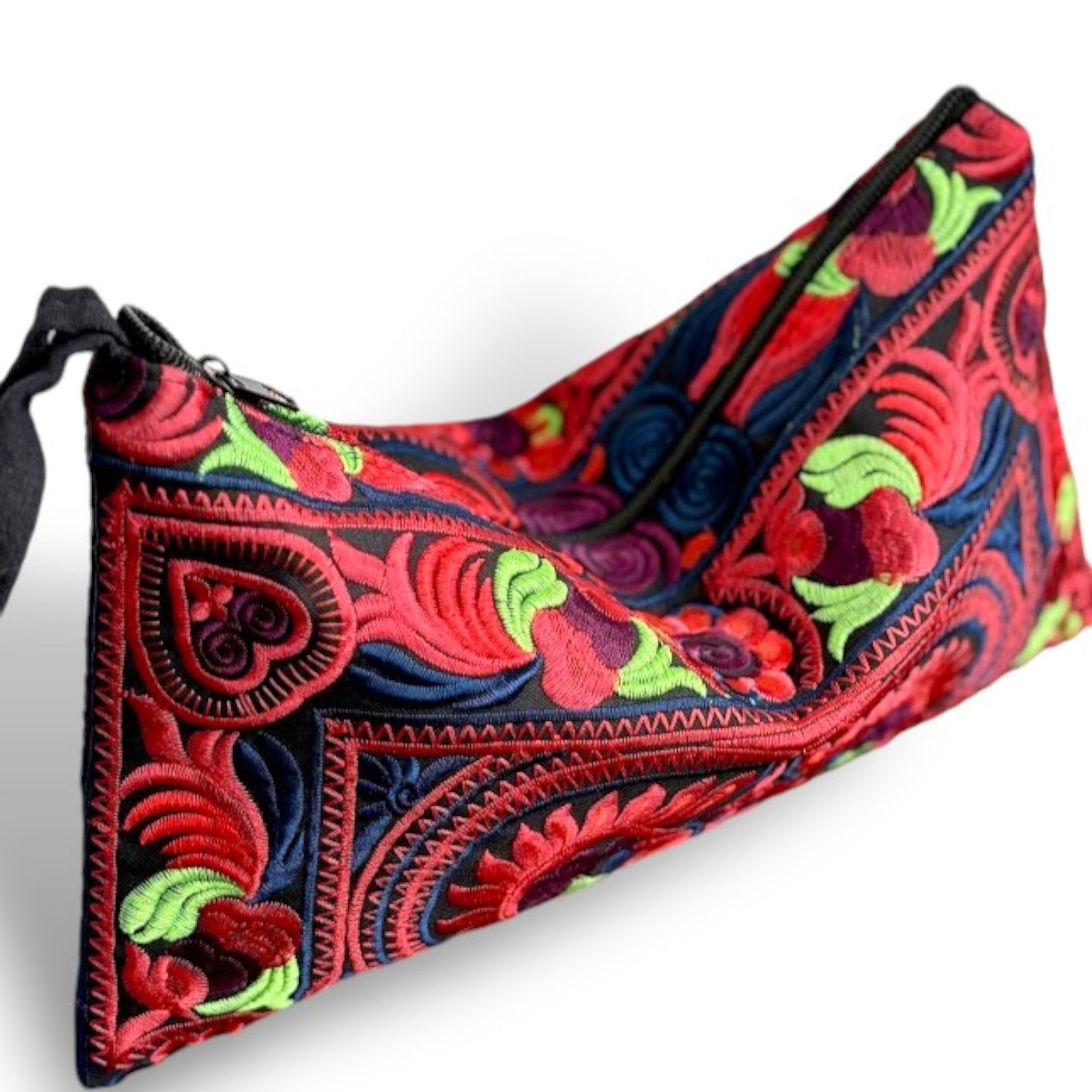 Hmong embroidered wristlet clutch styled with a casual outfit, showcasing vibrant red patterns.