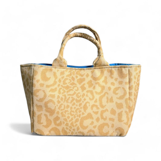 Handmade yellow leopard-print mini tote with top handles and blue lining.