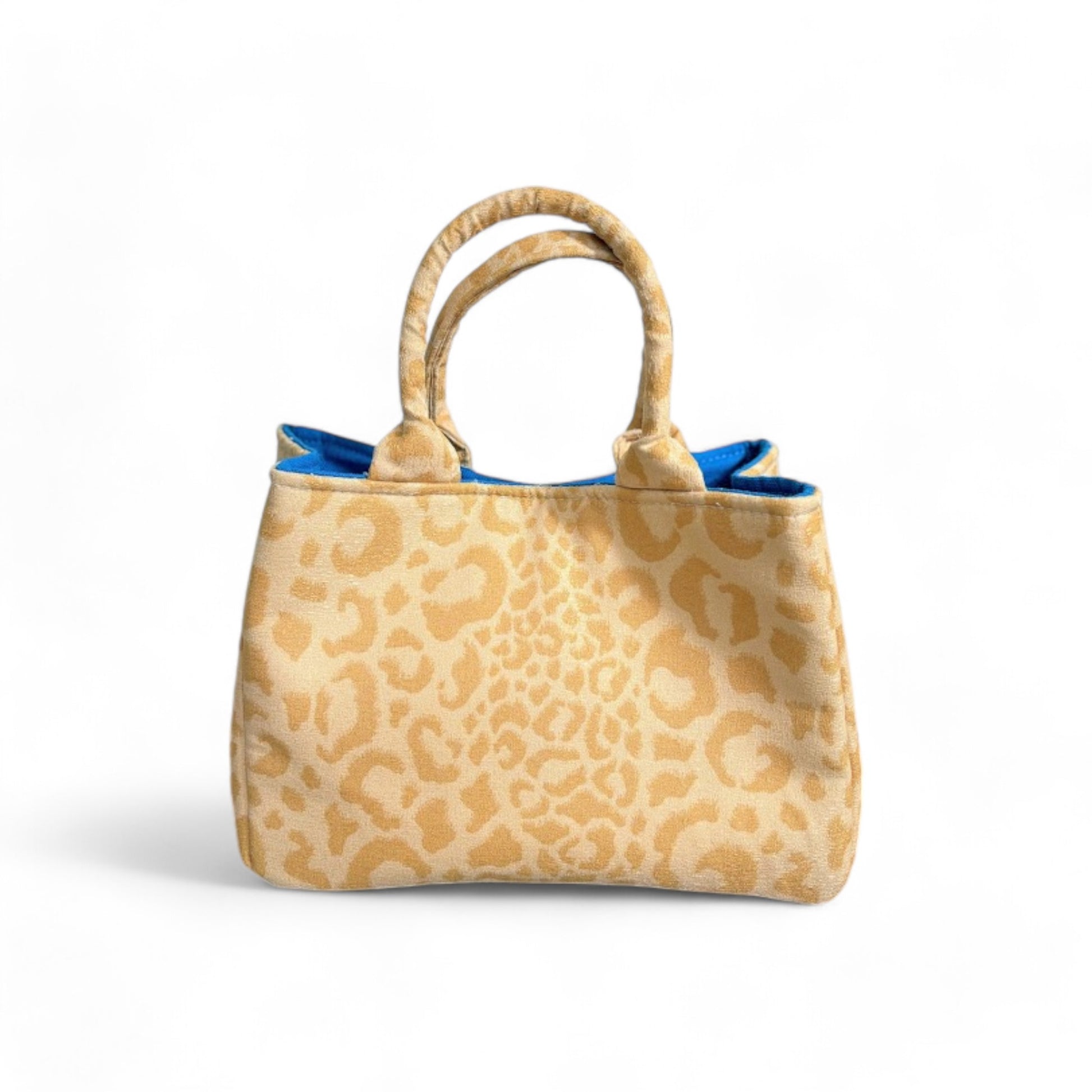 A handmade yellow leopard fabric mini bag with blue interior.
