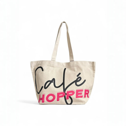 Oversized Café Hopper tote with long handles and modern lettering design for everyday carry.
