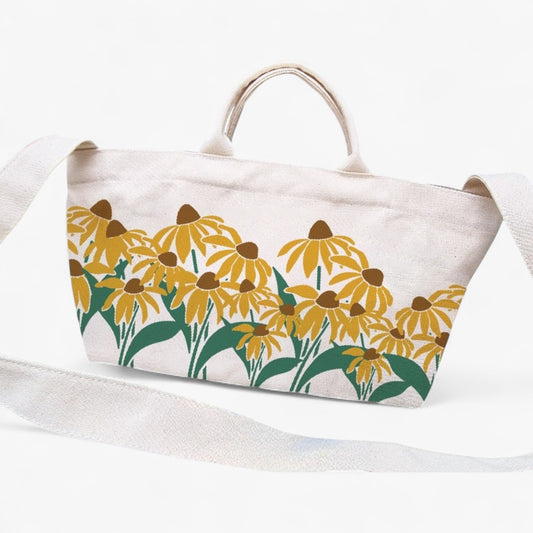 Canvas tote bag with sunflower print and shoulder strap and top handles.