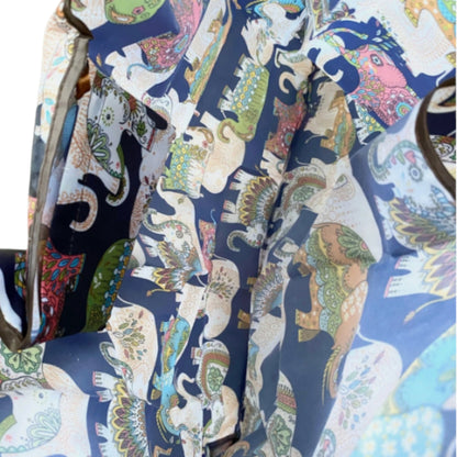 Inside of a navy nylon tote bag with colourful elephant paterns.
