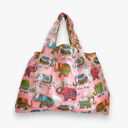 View from the front of a pink nylon tote bag with colourful elephant patterns.