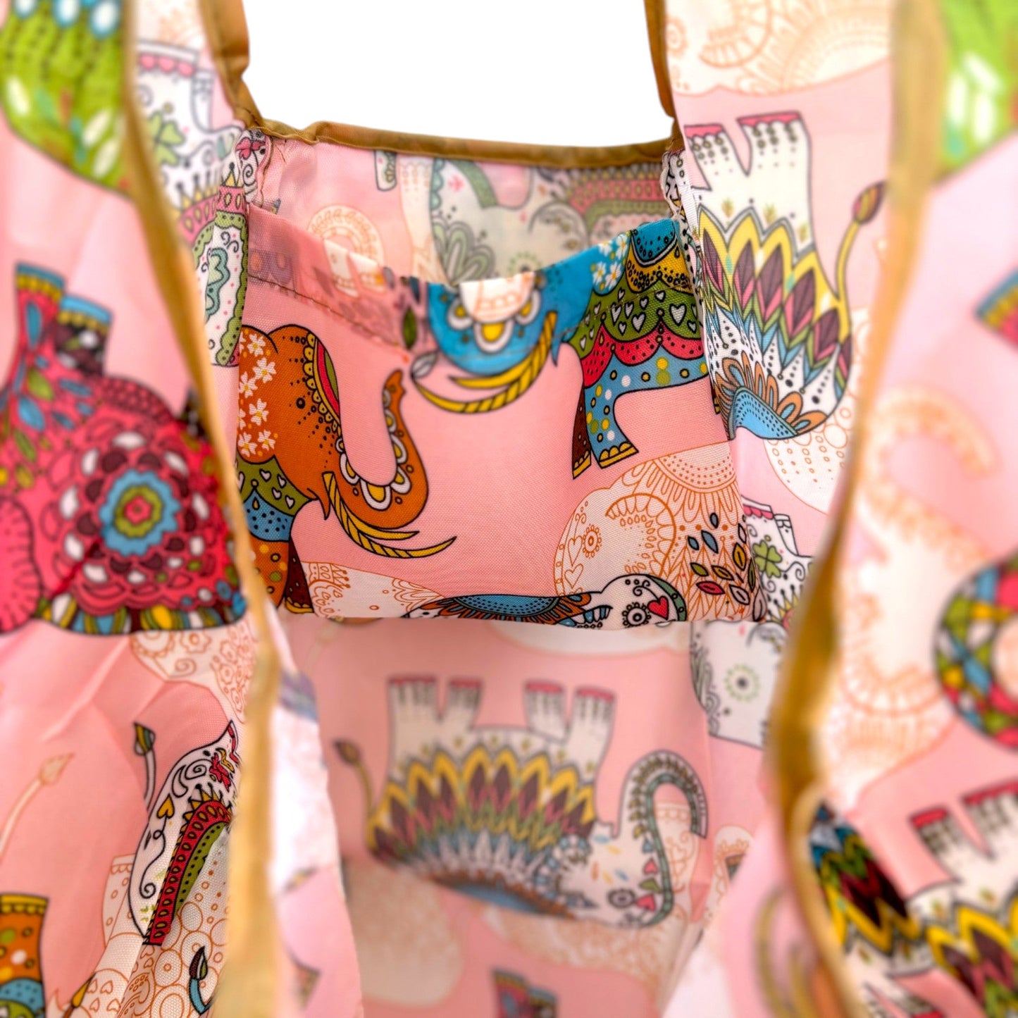Interior of a pink elephant tote bag showing a pocket and a large capacity.