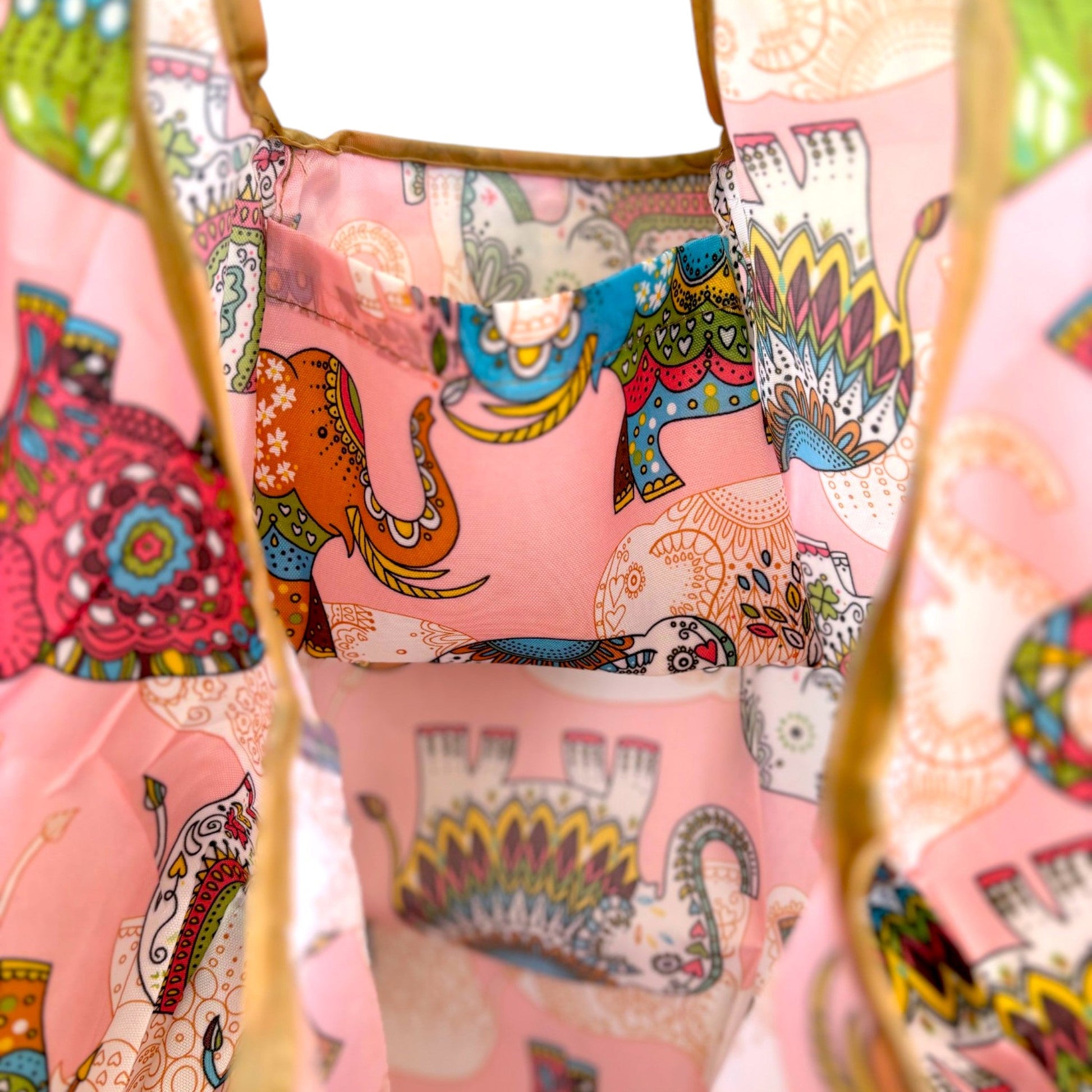 Interior of a pink elephant tote bag showing a pocket and a large capacity.