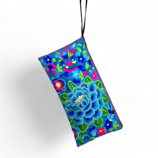 Front view of an embroidered rectangle bag with a blue and pink floral pattern, and a strap.